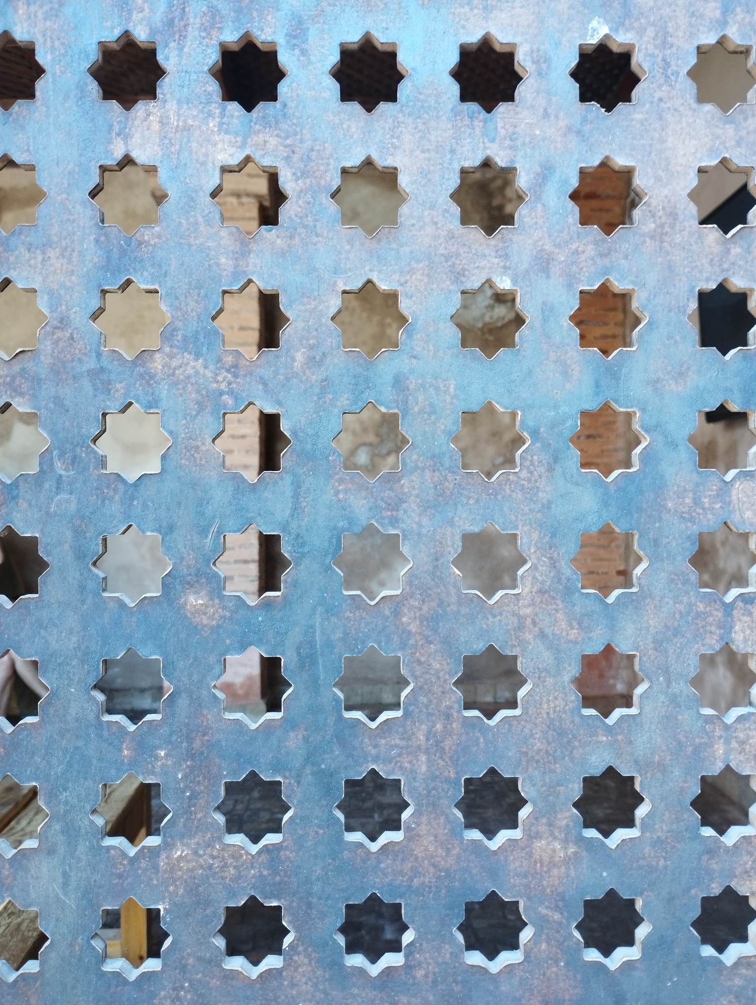 A blue and white Moroccan lattice screen